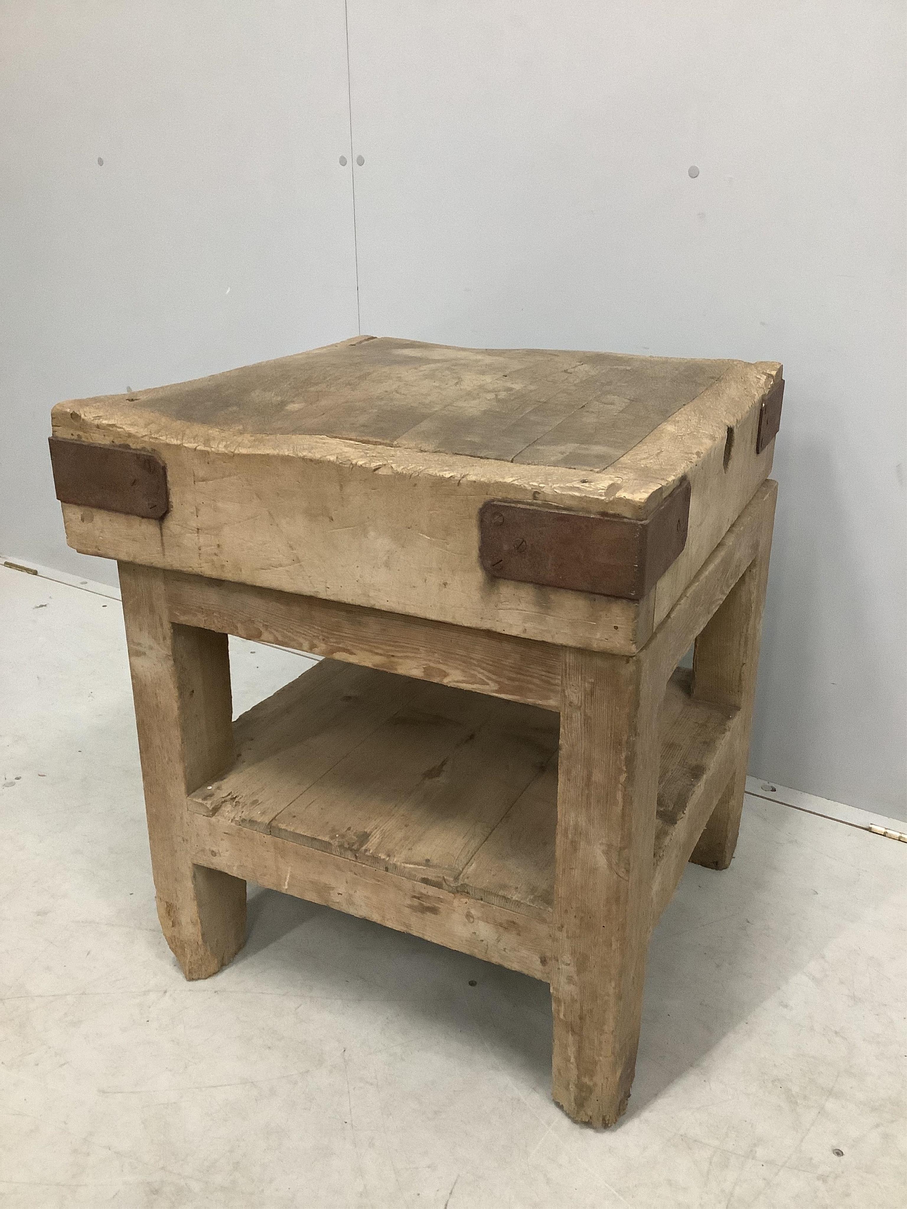 A Victorian iron bound butcher's block on pine stand, width 62cm, depth 61cm, height 68cm. Condition - fair